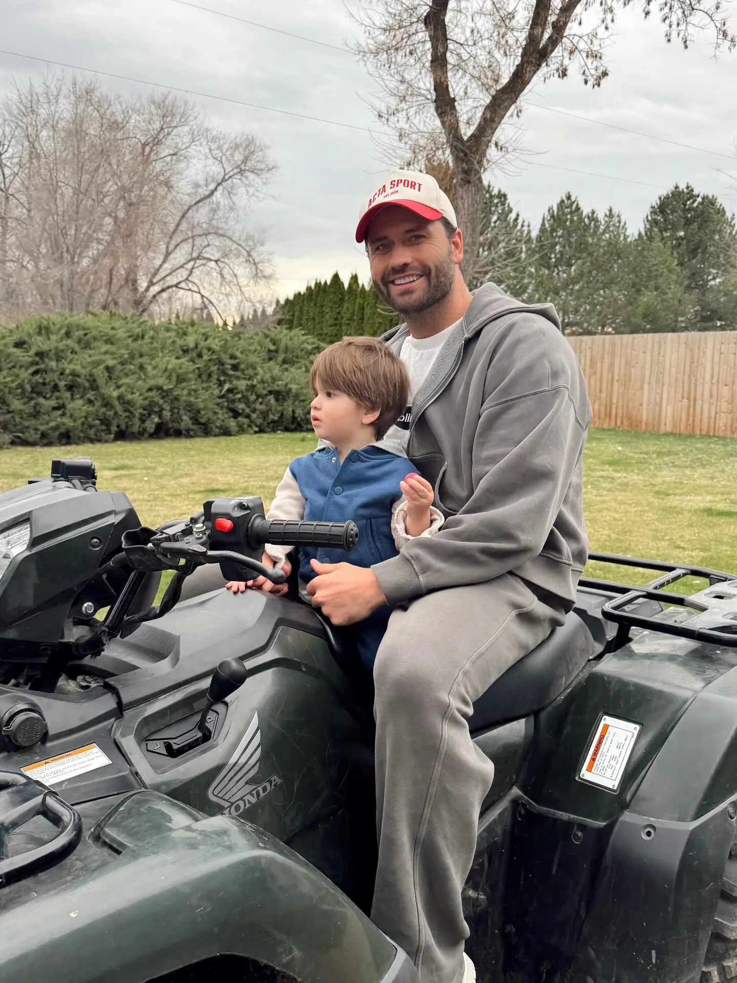 Dakota Mortensen and his son Ever riding an ATV.