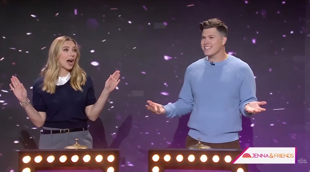 Scarlett Johansson and Colin Jost on a game show set.