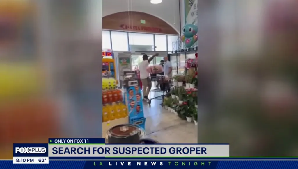 Security camera footage of a man in a grocery store at the entrance.