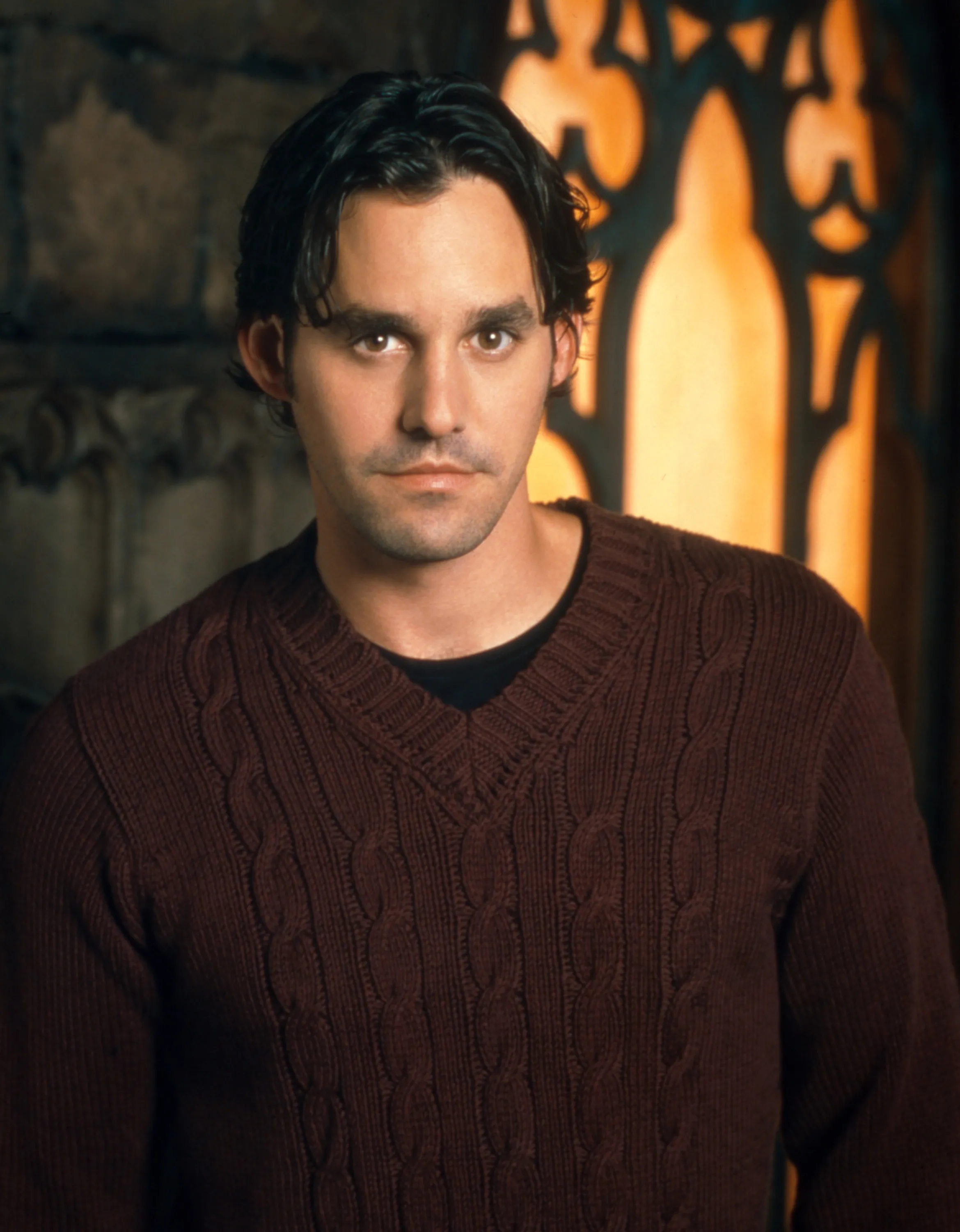 Nicholas Brendon as Xander in a brown cable-knit sweater.