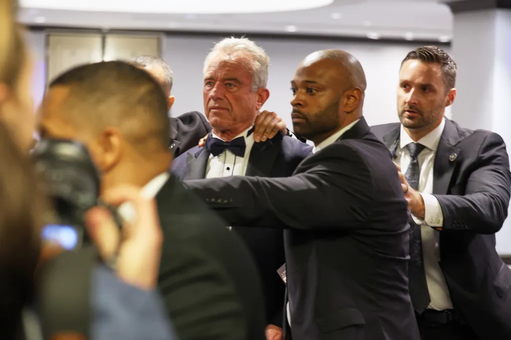 Security rapidly escort Secretary of Health and Human Services Robert F. Kennedy, Jr. out during the White House Correspondents Dinner, Saturday, April 25, 2026.