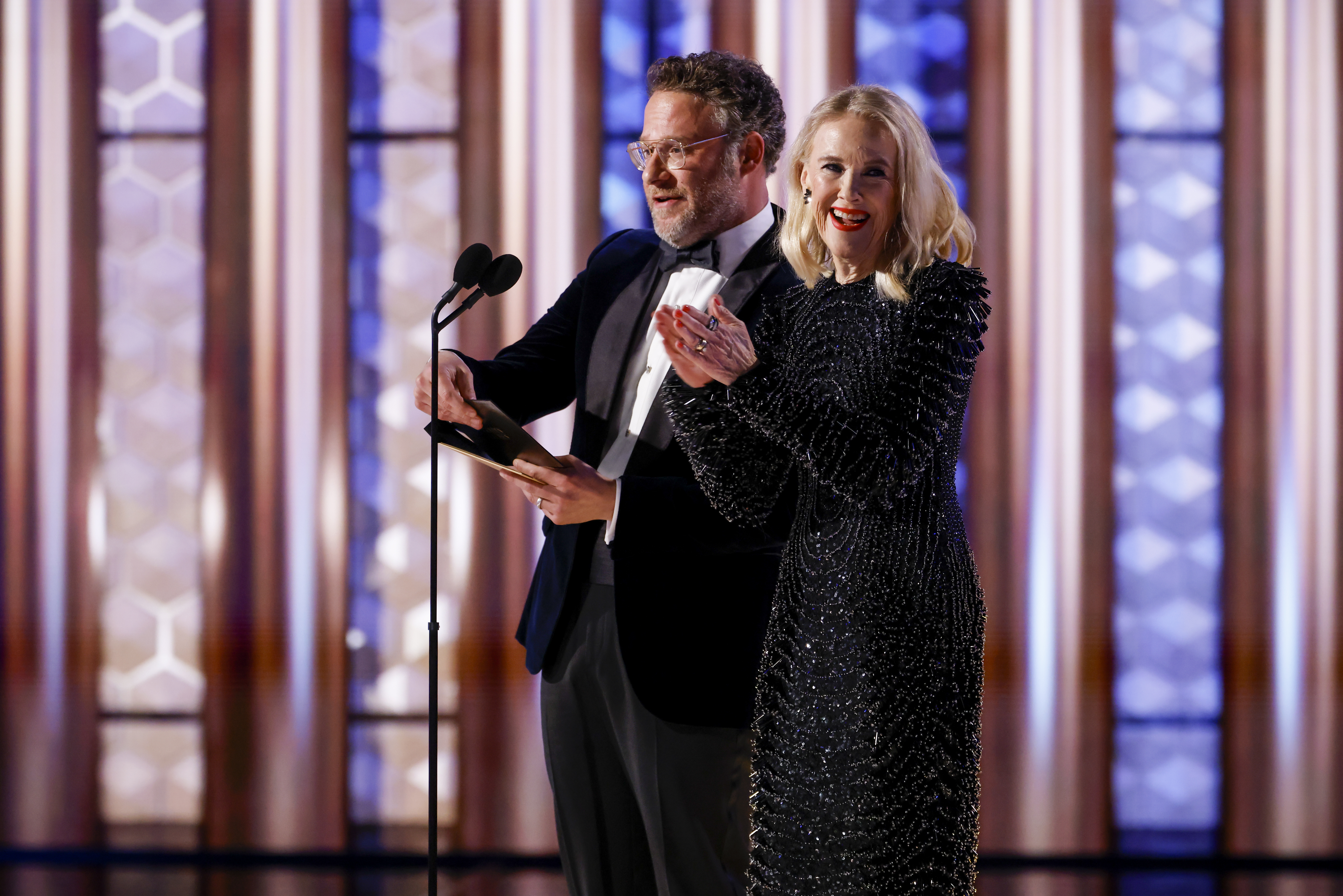 Seth Rogen and Catherine O'Hara speak onstage at the 82nd Annual Golden Globe Awards.