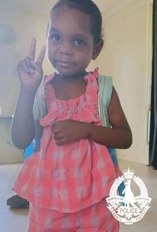 Sharon Granites, a five-year-old girl, making a peace sign with her fingers.