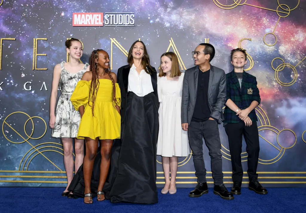 Angelina Jolie laughing with her six children, Shiloh, Zahara, Vivienne, Maddox, and Knox Jolie-Pitt, at the "Eternals" premiere.