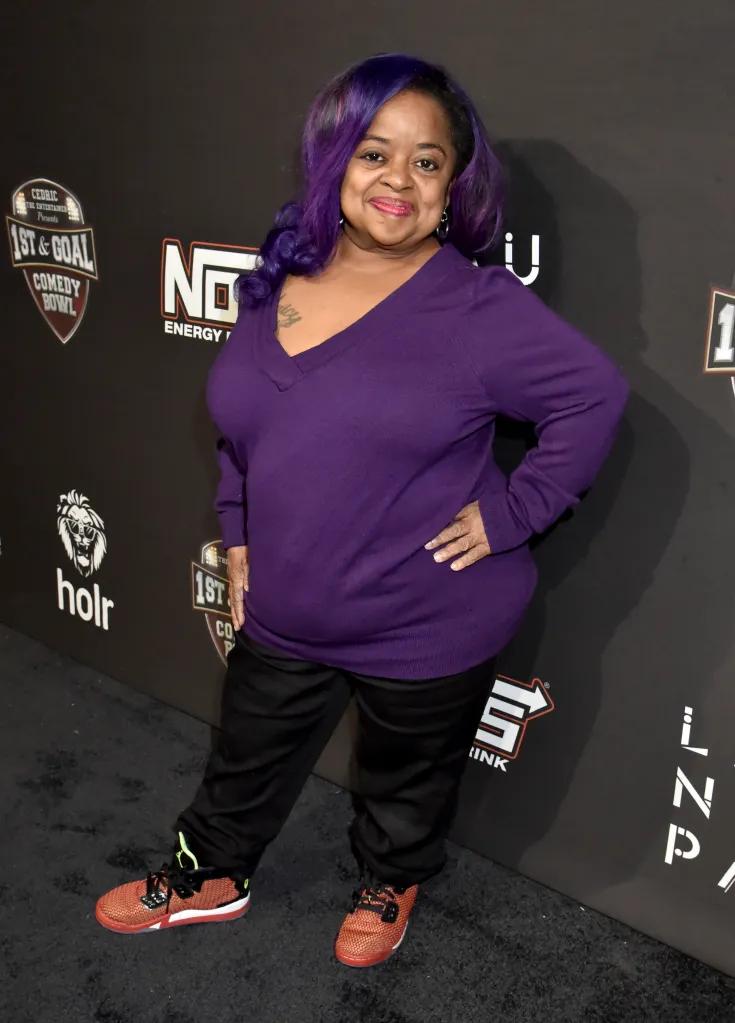 Shirlene "Ms. Juicy" King Pearson posing on a black carpet with event branding in the background.