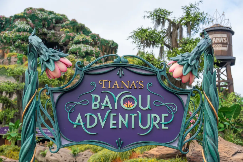 Sign for Tiana's Bayou Adventure log flume ride at Disney World.