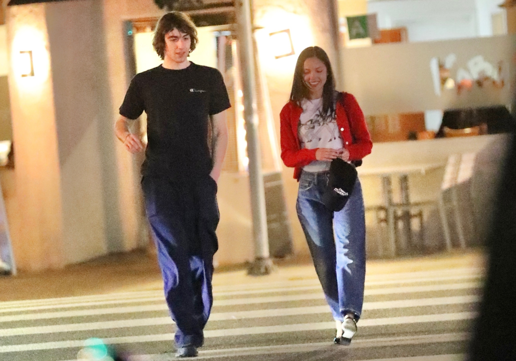Olivia Rodrigo and Cameron Winter walking together after a dinner date.
