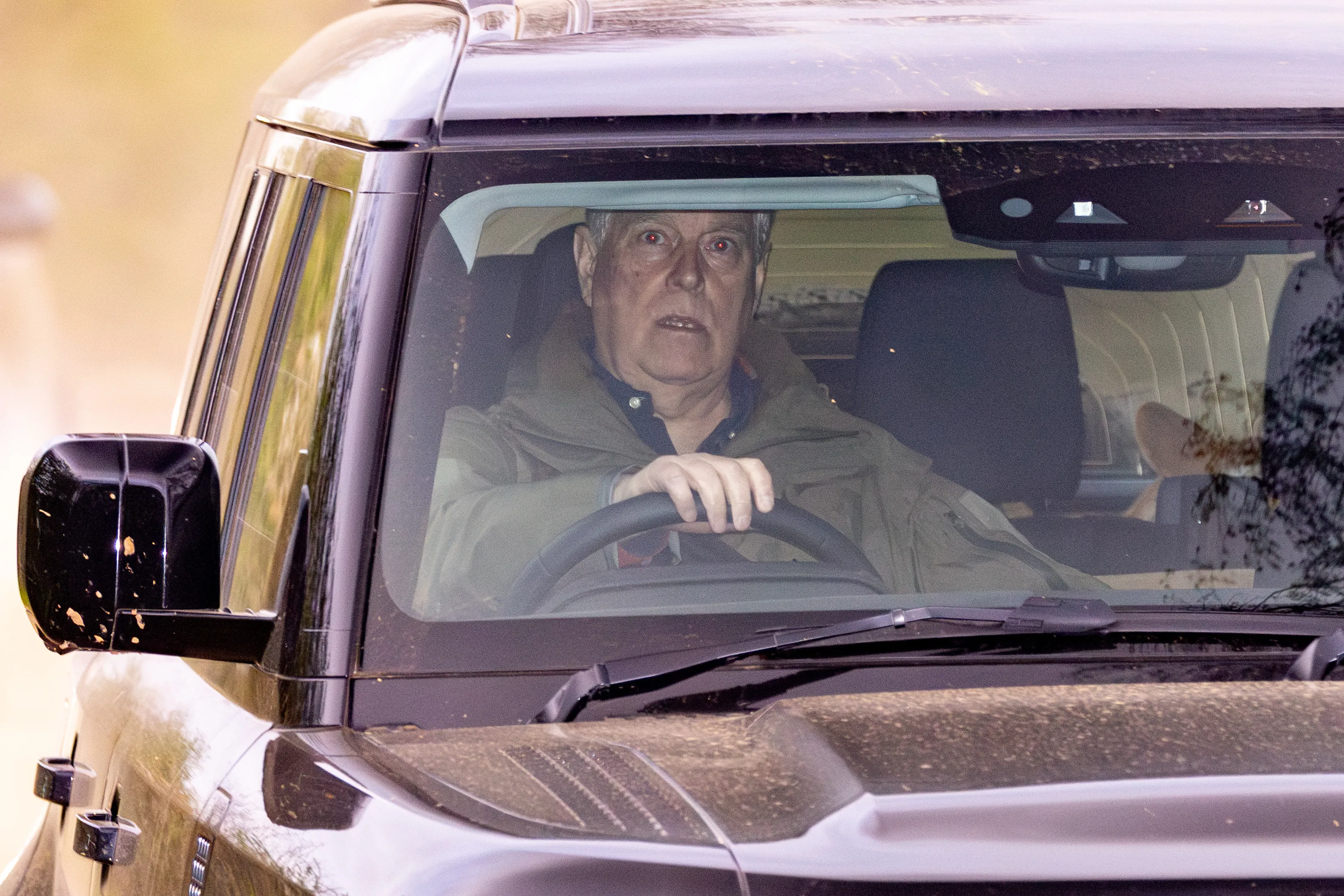 Prince Andrew driving a dark Range Rover.