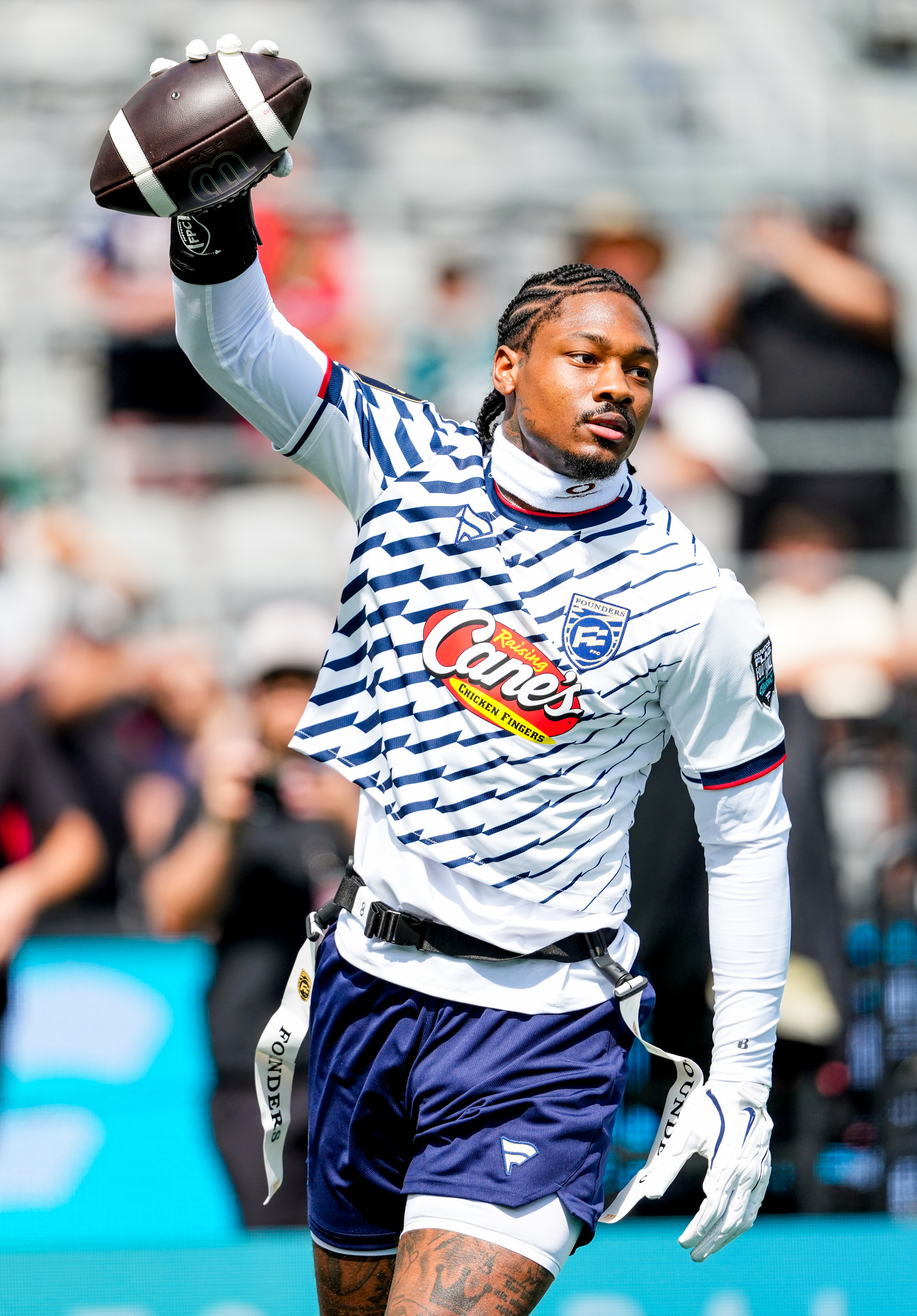 Stefon Diggs raising a football over his head during the Fanatics Flag Football Classic.