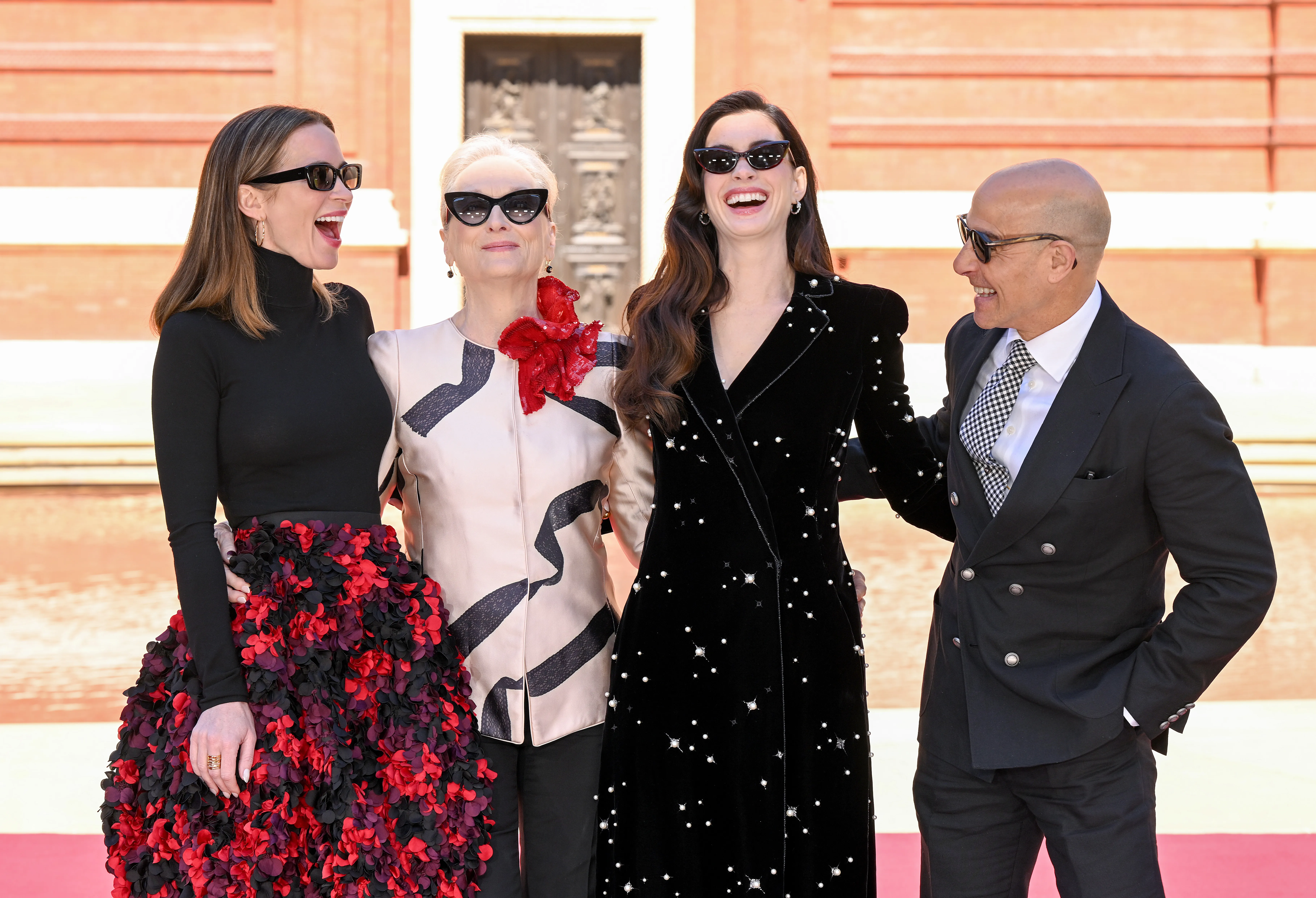 Meryl Streep, Anne Hathaway, Emily Blunt, and Stanley Tucci pose together.