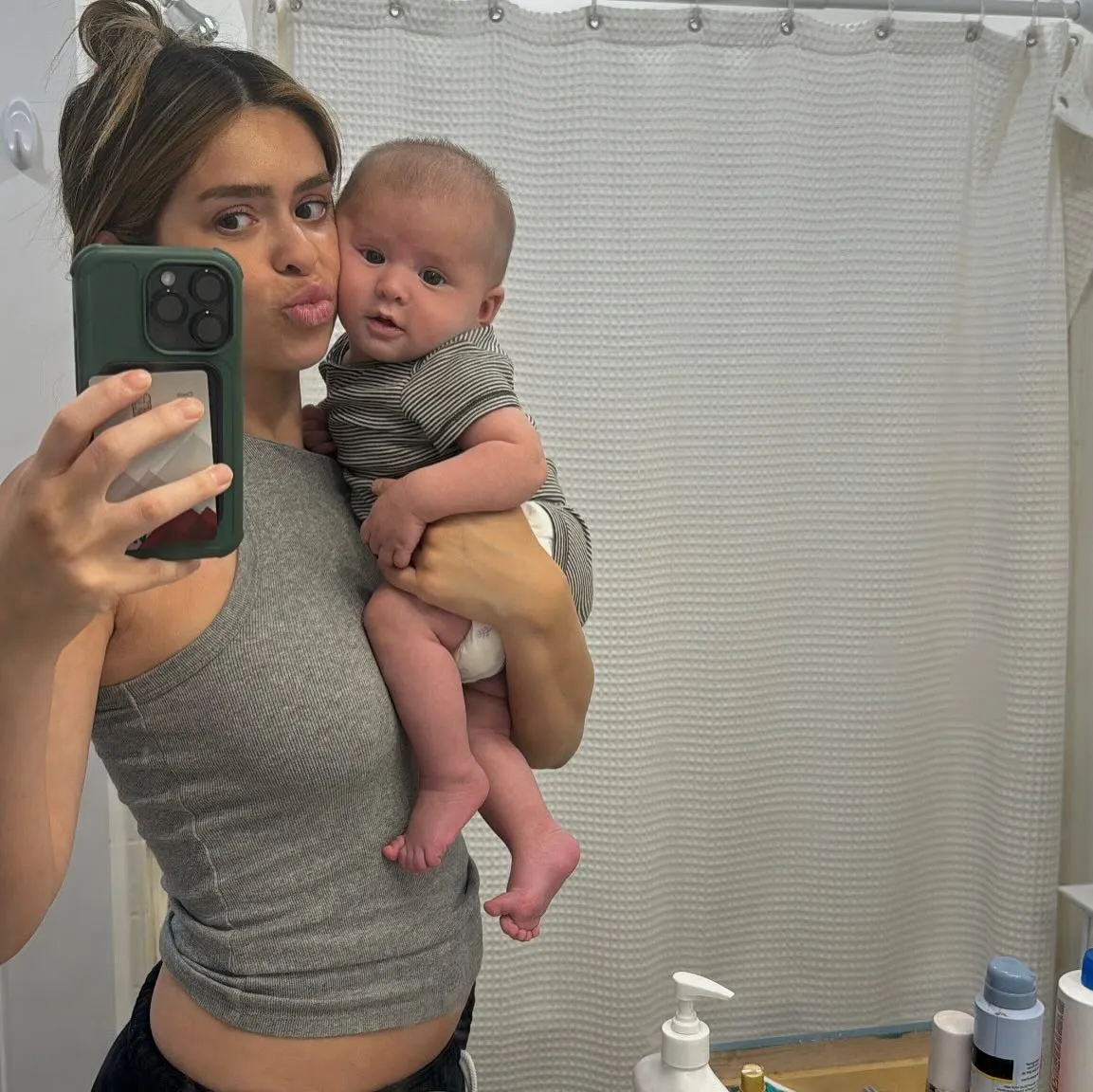Taylor Frankie Paul holding her baby and taking a mirror selfie.