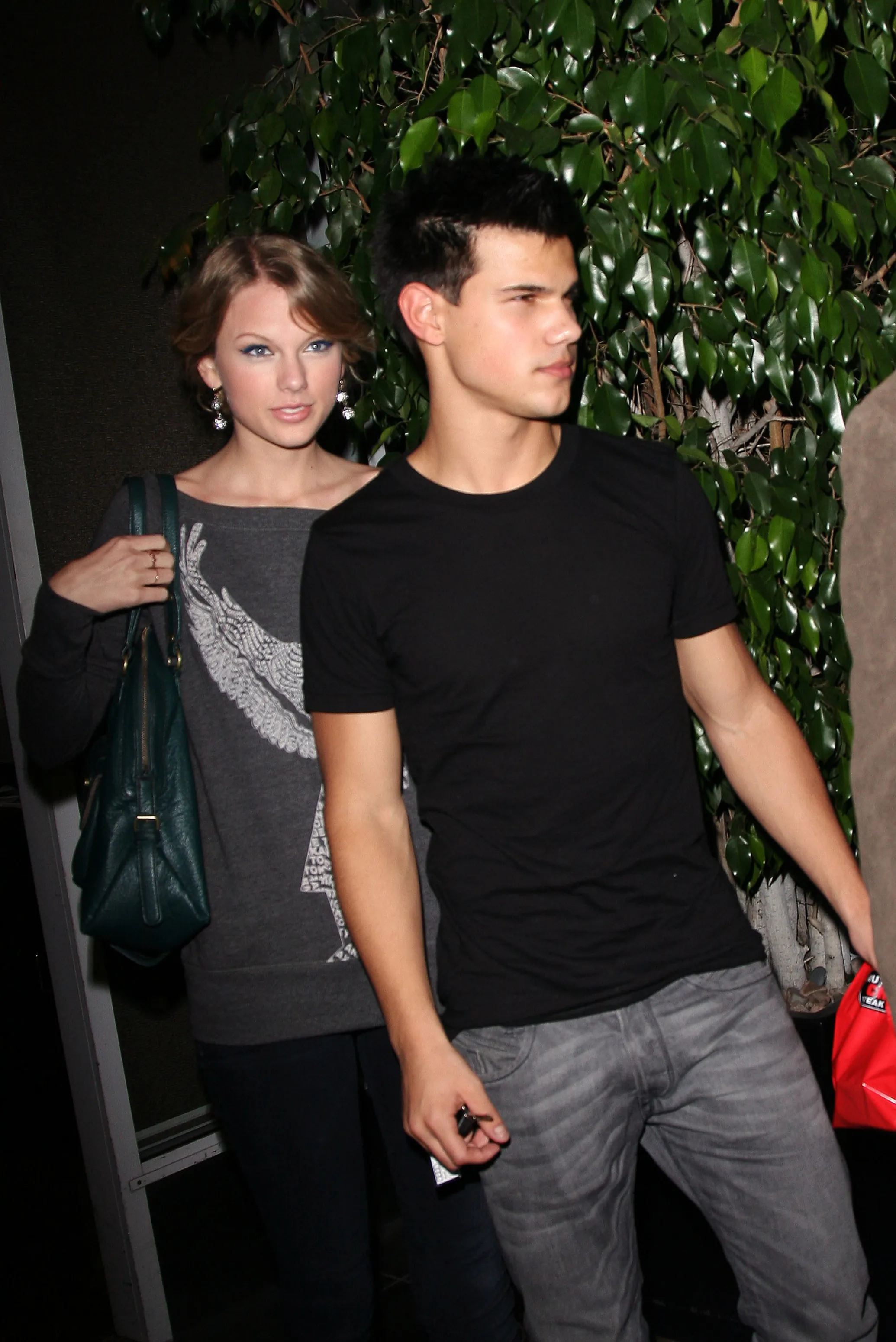 Taylor Swift and Taylor Lautner walking together.