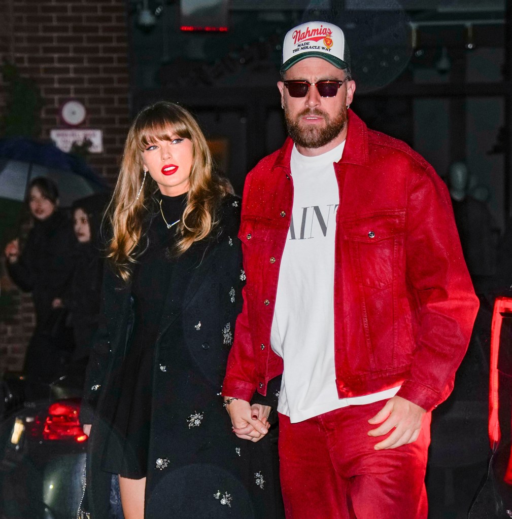 Taylor Swift and Travis Kelce holding hands while walking.