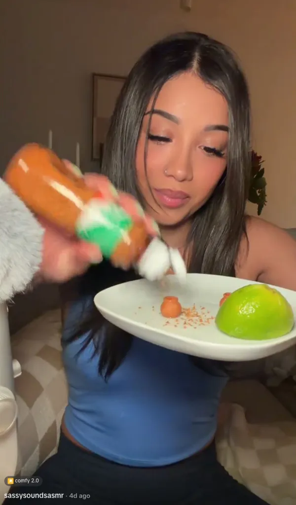 A woman adding Tajín to small clay pots and lime.
