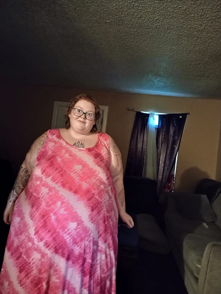 Dolly Martinez from My 600-lb Life in a pink and white tie-dye dress.