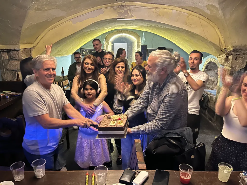 Barry Hoffner cutting a birthday cake with a young girl.