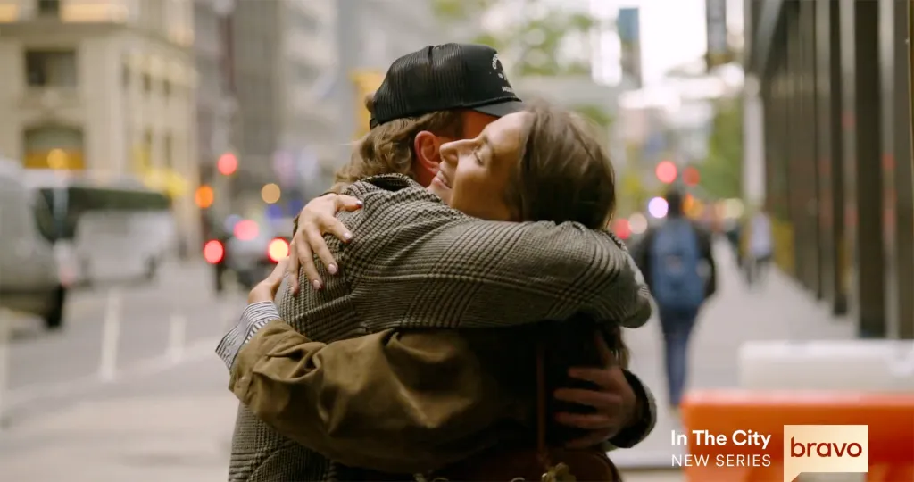 West Wilson and Amanda Batula embrace in a city street.