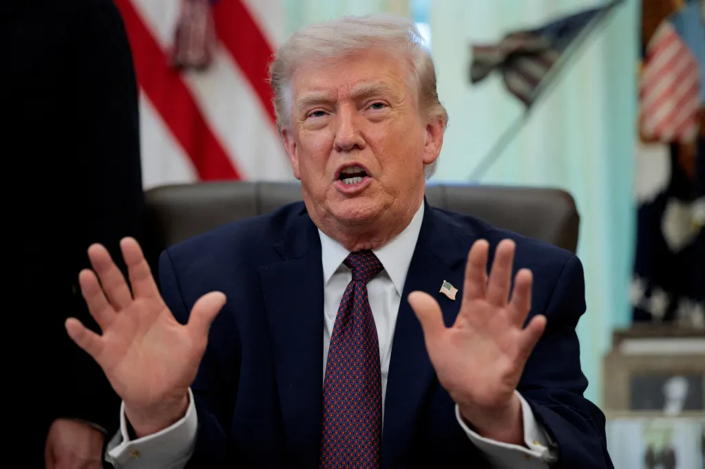 President Trump speaks in the Oval Office, gesturing with open hands.
