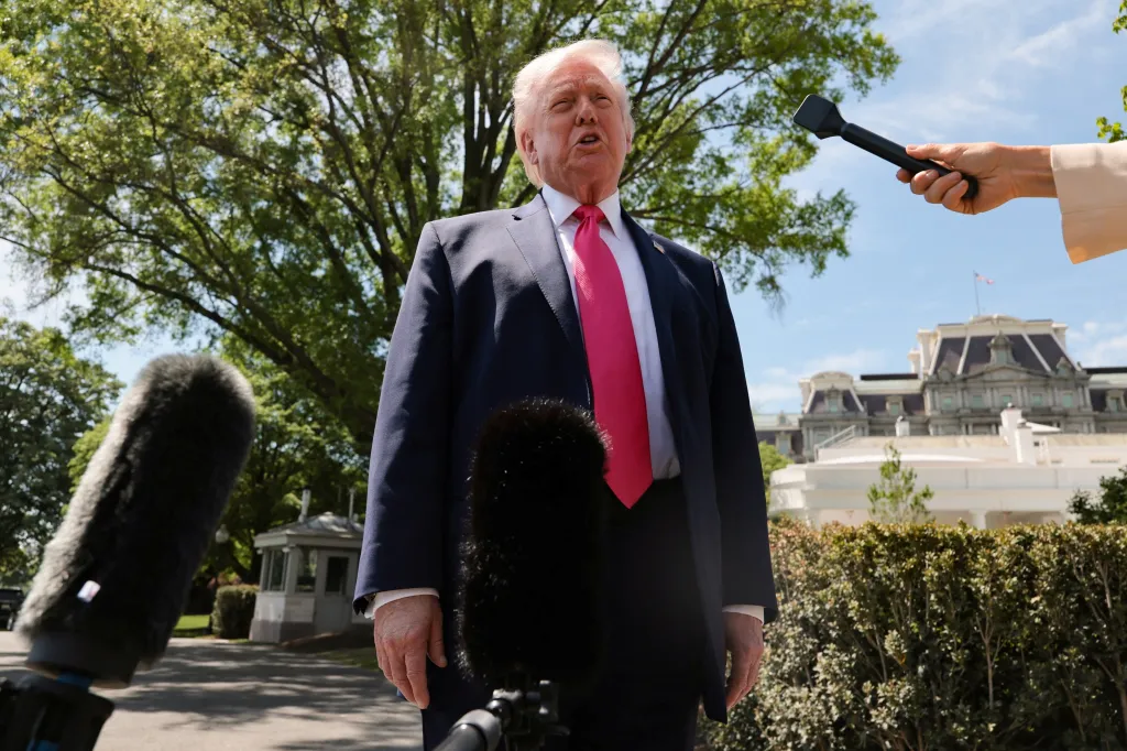 President Donald Trump speaks to reporters outside the White House.
