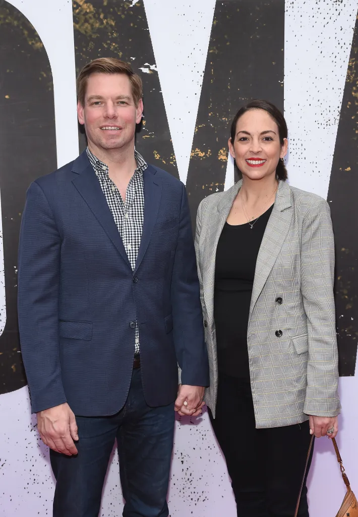Eric Swalwell and Brittany Watts holding hands.