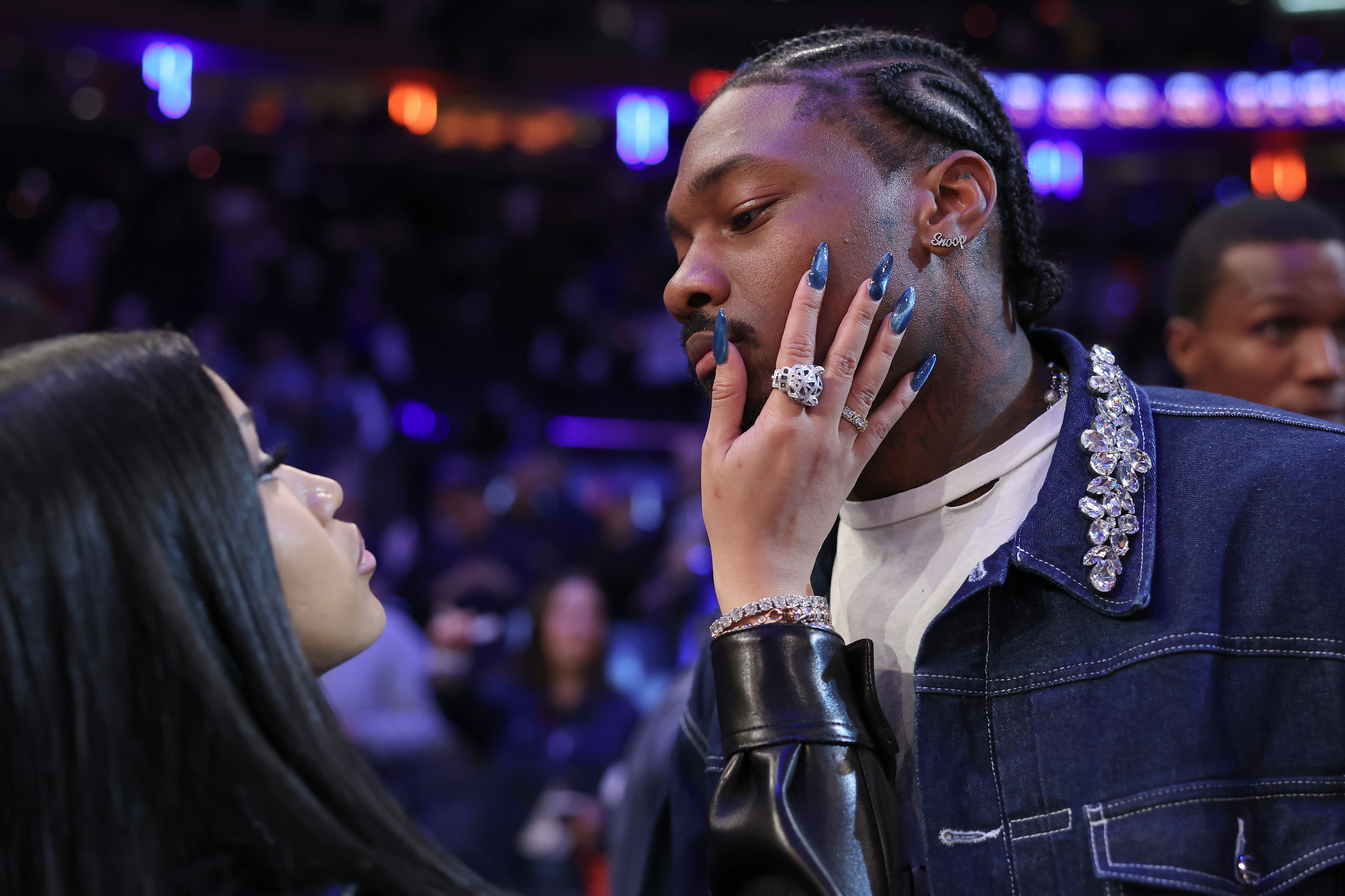 Cardi B looking at Stefon Diggs while holding his chin.