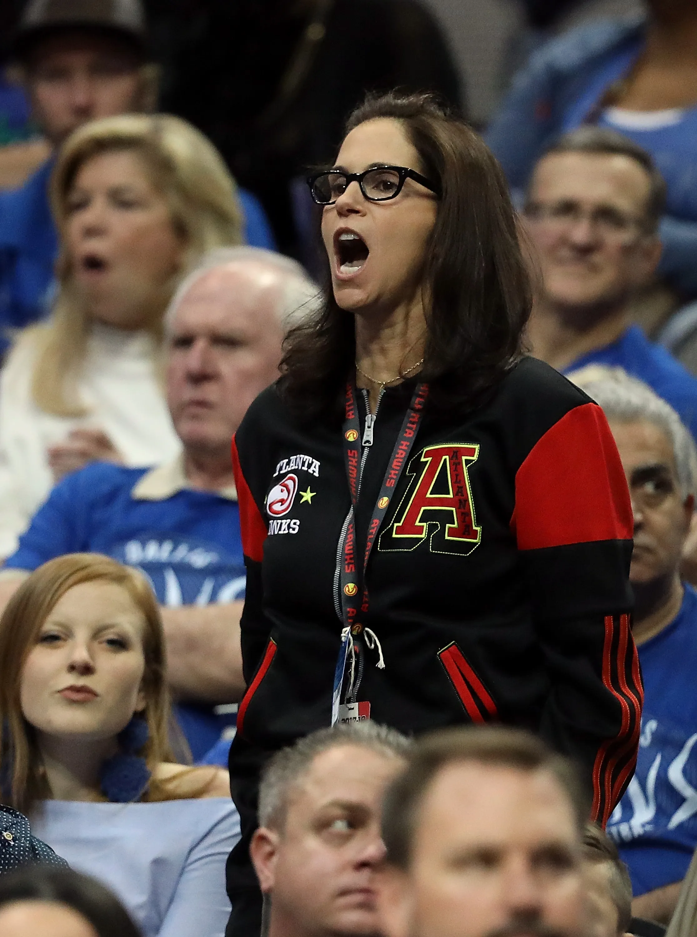 Jami Gertz cheering in a black and red Atlanta Hawks jacket.
