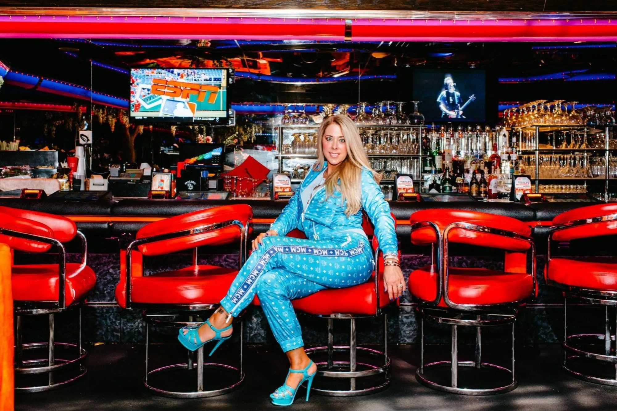 Tonia Ryan seated on a red bar stool.