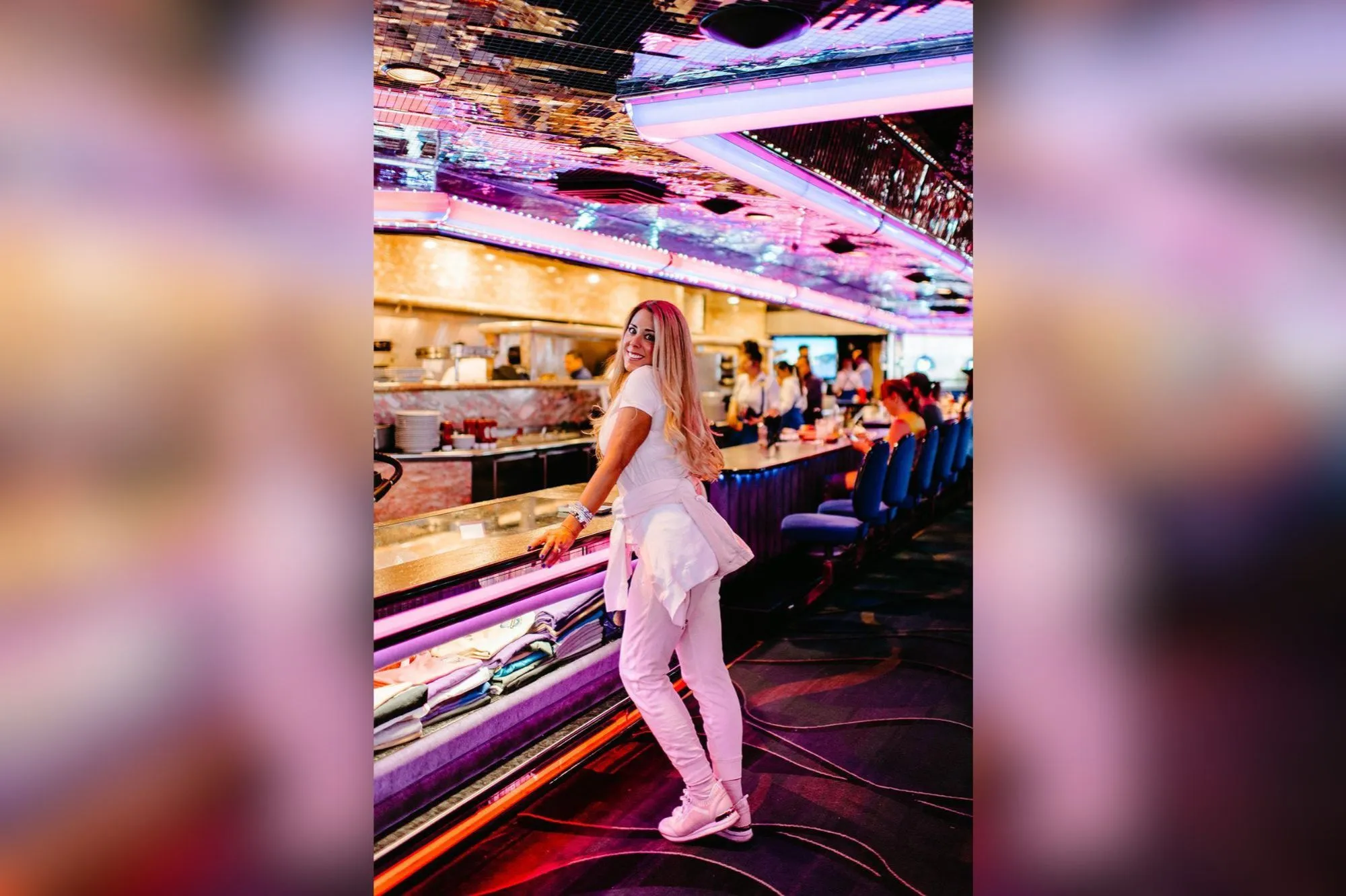 Tonia Ryan standing in a diner-like setting with colorful lights.