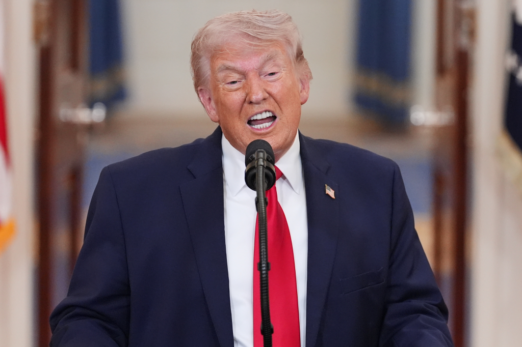 Donald J. Trump speaking at a podium with a microphone.