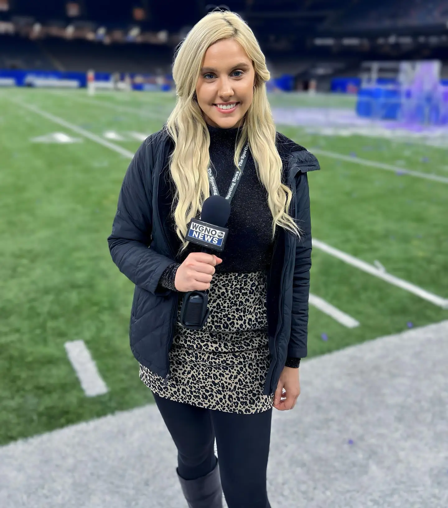 NFL reporter Crissy Froyd standing on a football field holding a WGNO News microphone.