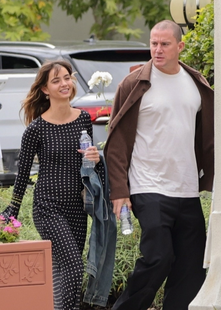 Channing Tatum and Inka Williams walking outside, holding water bottles.