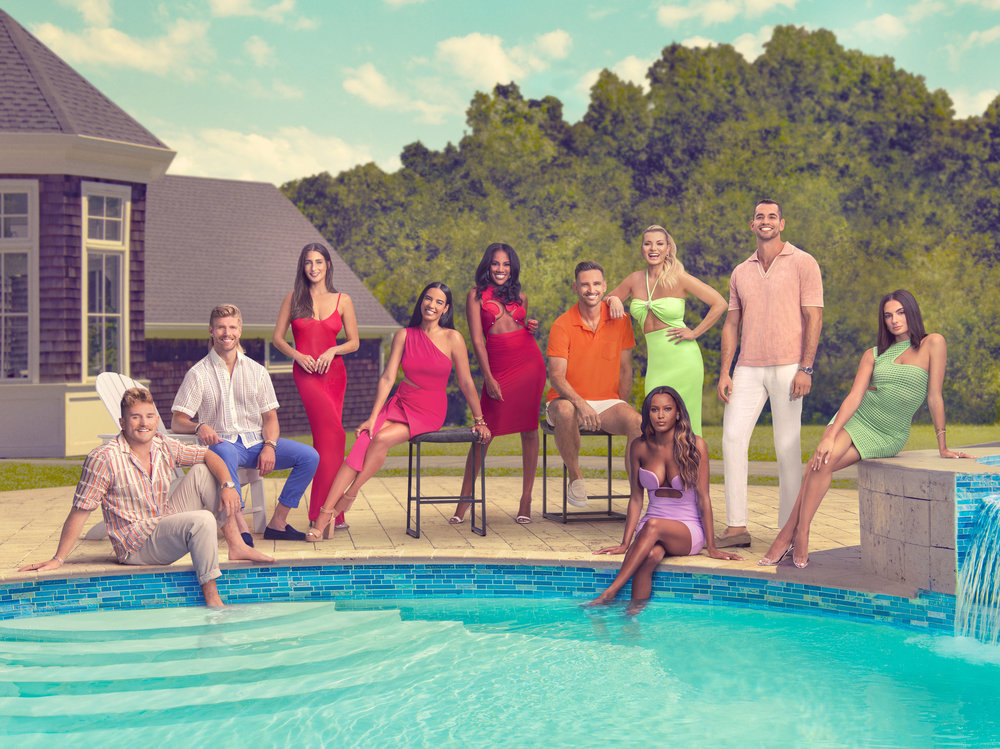 The cast of Summer House Season 8 posing around a swimming pool.