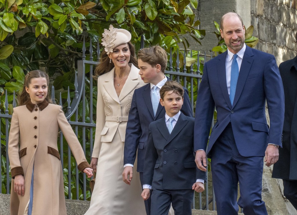 From left: Princess Charlotte, in a light brown coat with dark brown trim, Kate Middleton in a cream skirt suit and cream hat, Prince George in a blue suit, white shirt and blue tie, Prince Louis, in a blue suit, blue tie and white shirt, Prince William in a blue suit, blue tie and white shirt, departing Easter Matins Service at St. George's Chapel, Windsor Castle.