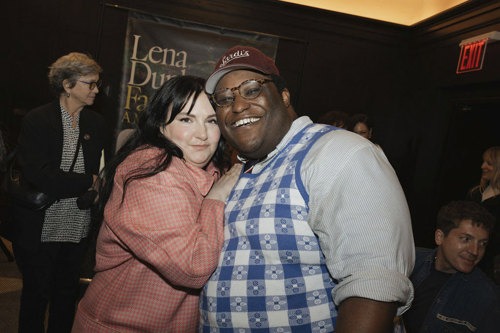 Lena Dunham poses with a guest at her memoir celebration event.