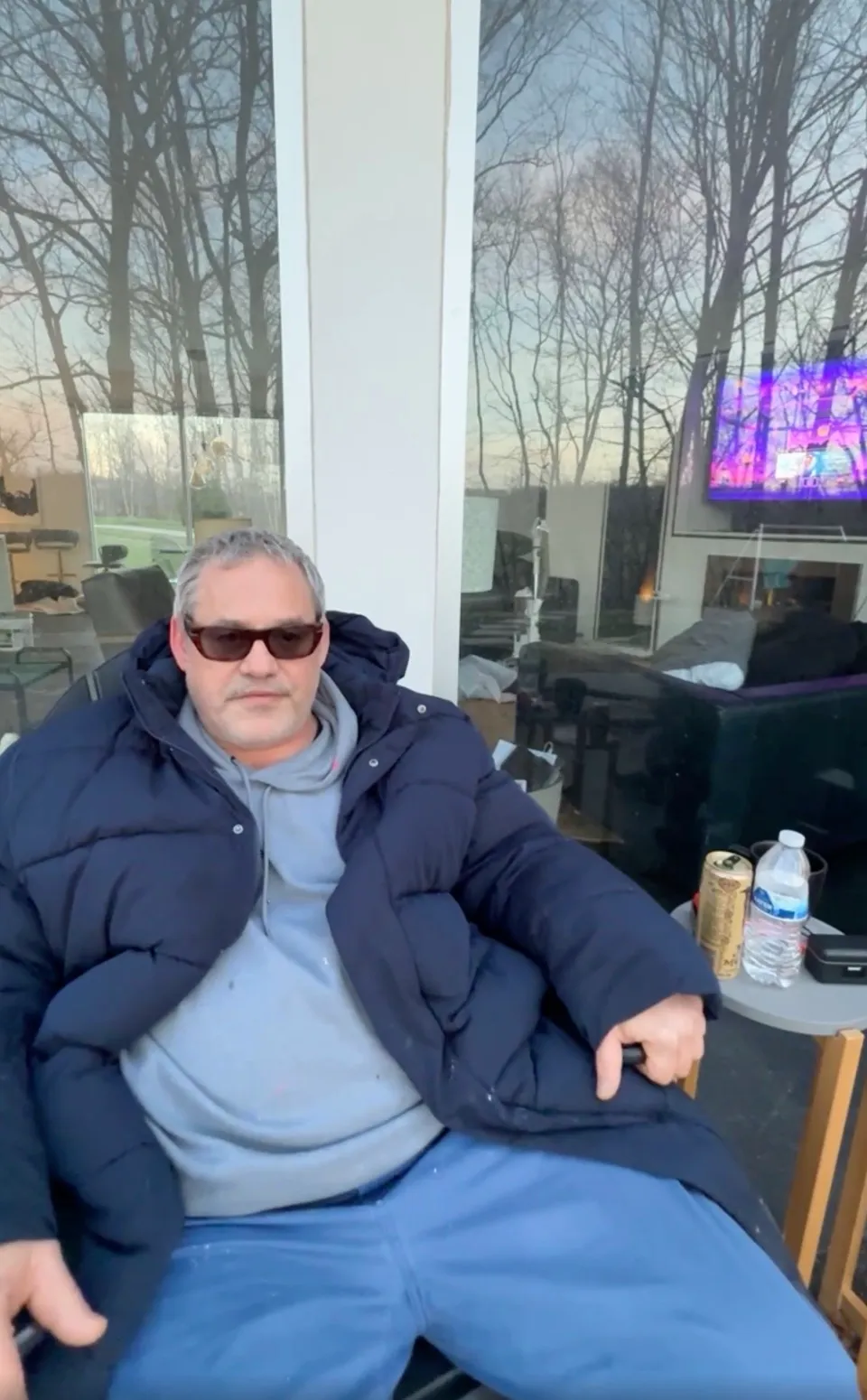 Nicholas Brendon in a navy puffer jacket and sunglasses.
