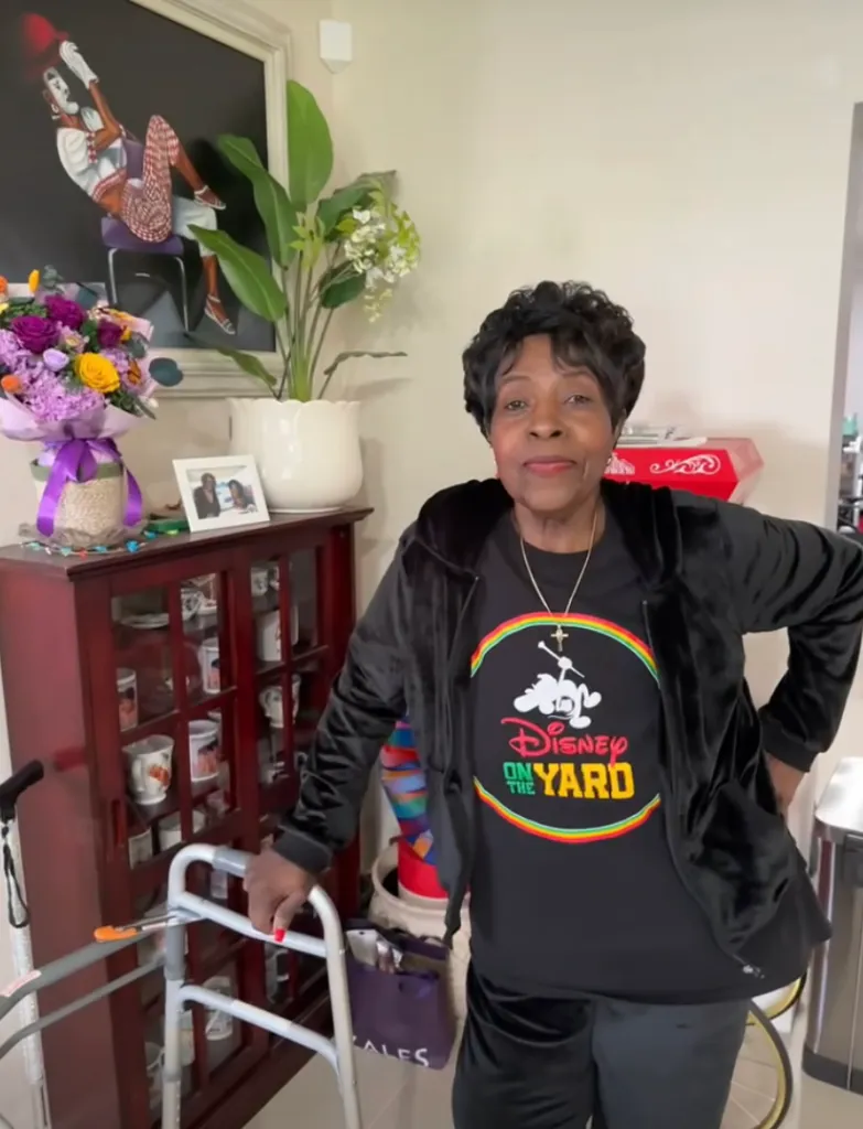 JoMarie Payton in a black outfit with a "Disney On the Yard" shirt.