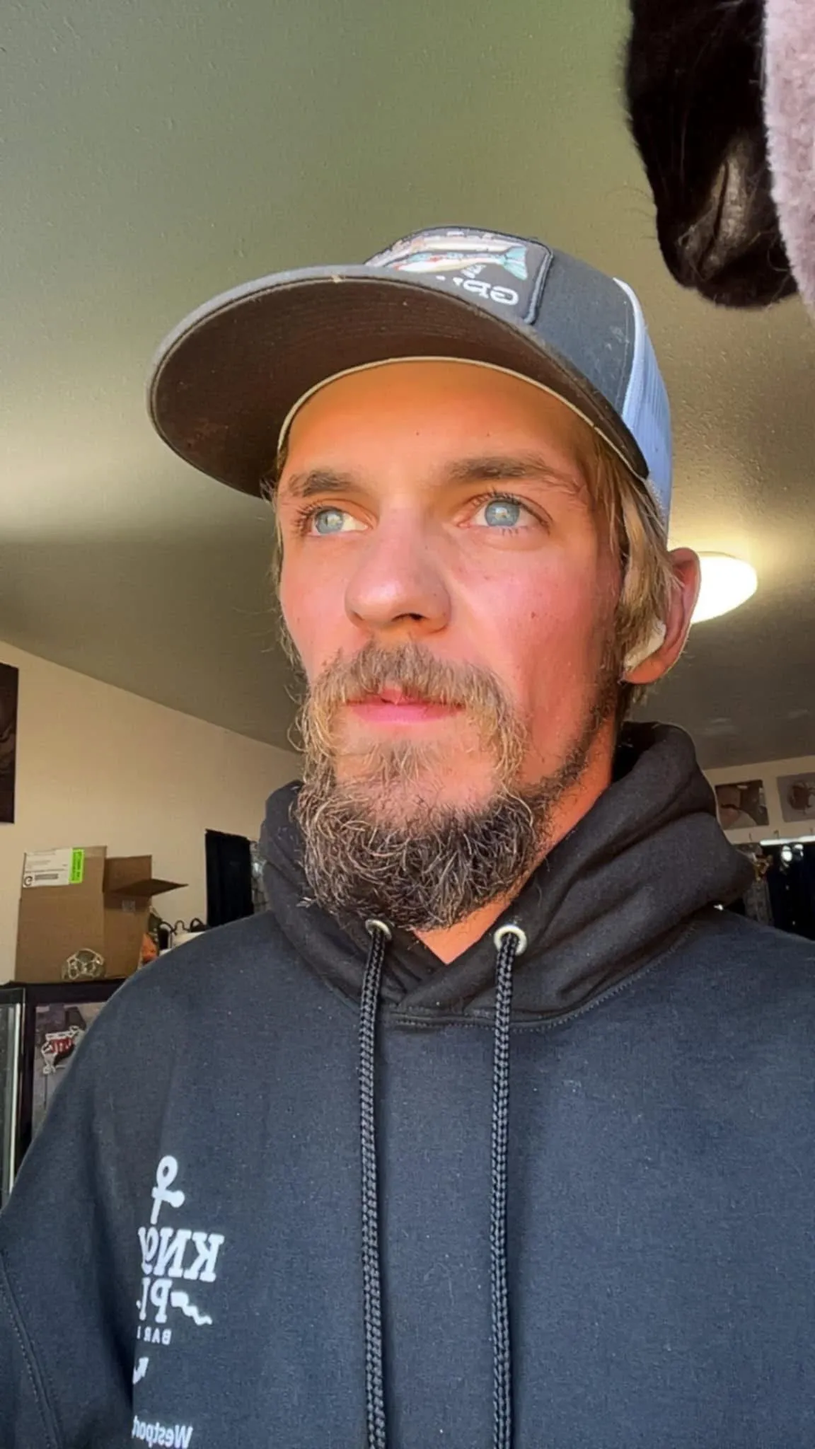 Todd Meadows, of Deadliest Catch, wearing a hat and black hoodie, looking away from the camera.