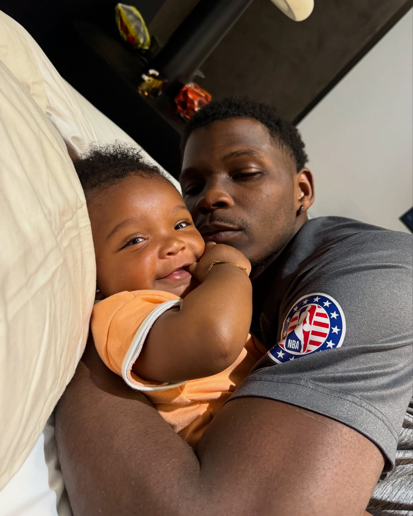 NBA player Anthony Edwards holding a baby.