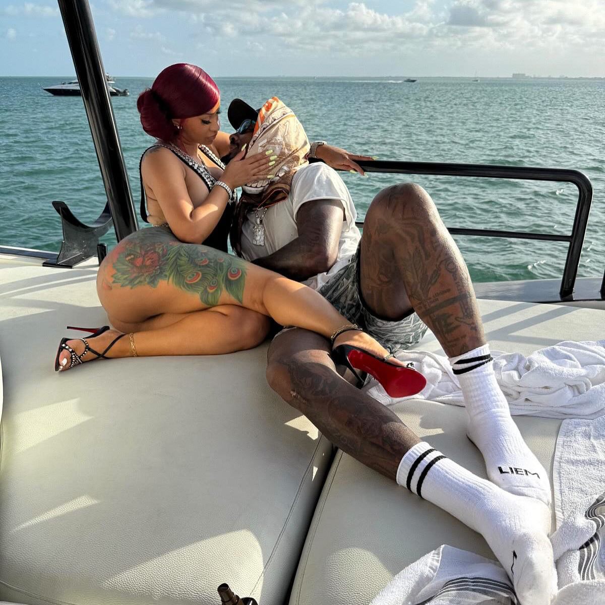 Cardi B sitting on a boat with Stefon Diggs.