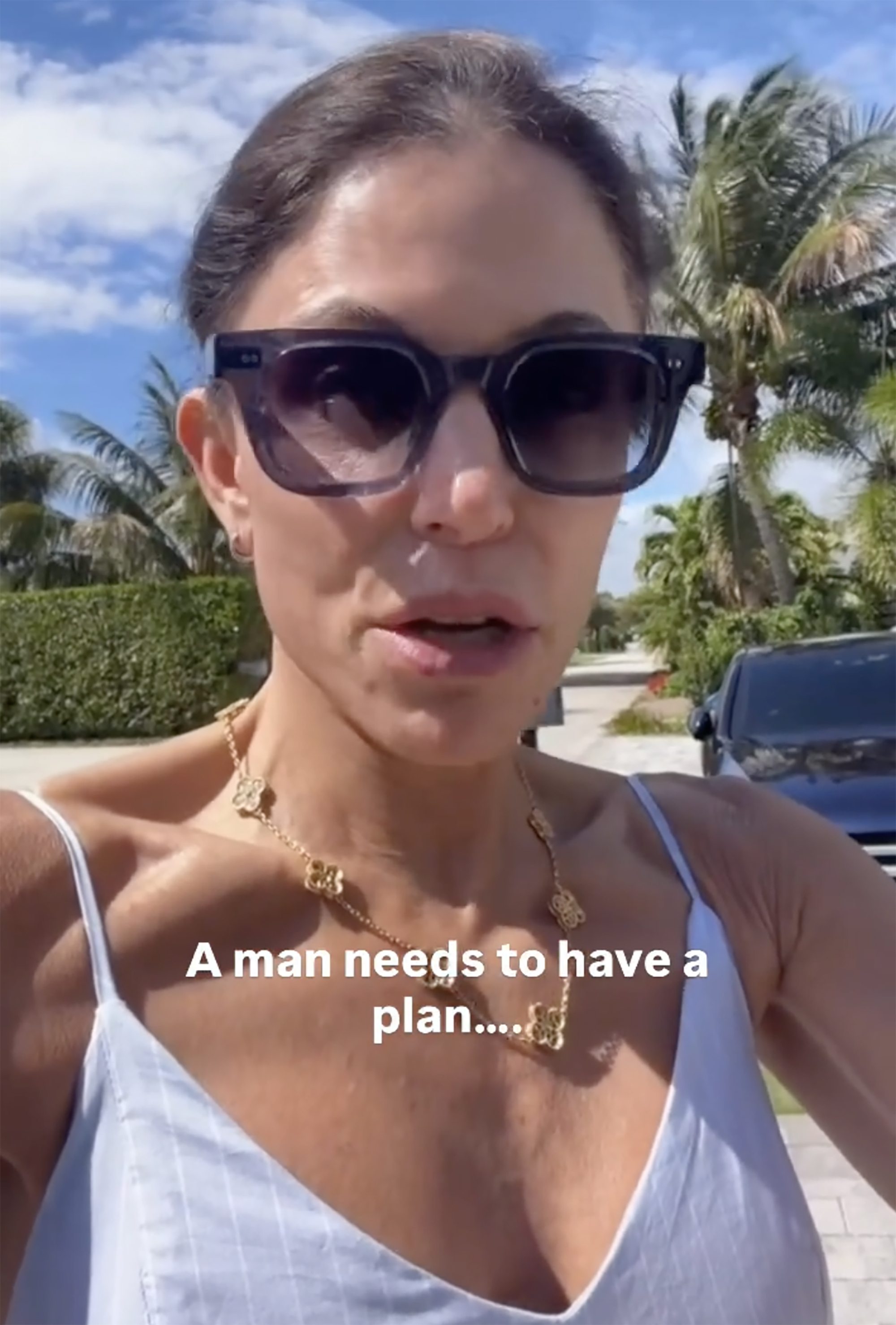 Bethenny Frankel outdoors wearing sunglasses and a gold necklace.