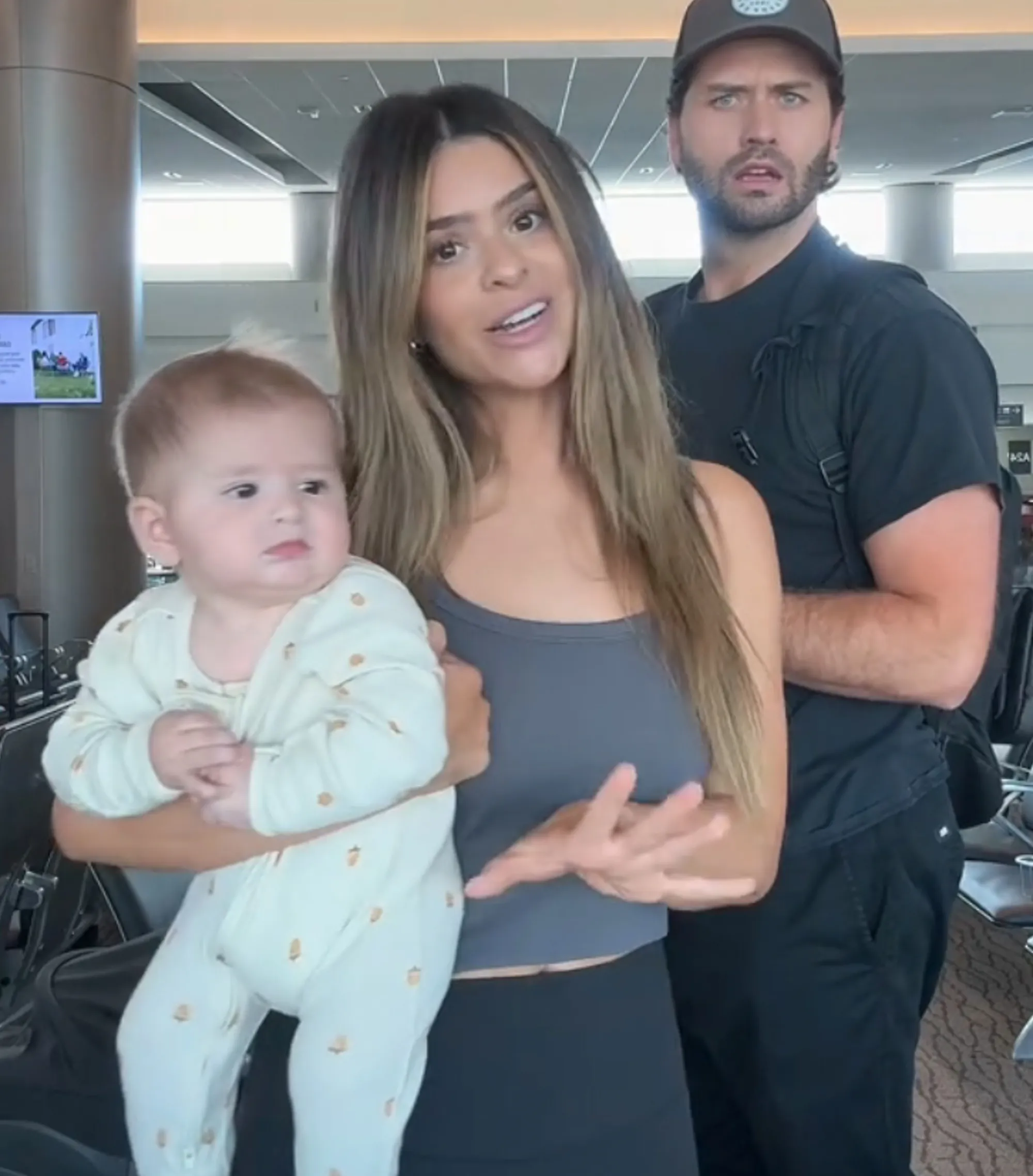 Taylor Frankie Paul holding her baby, standing next to Dakota Mortensen.