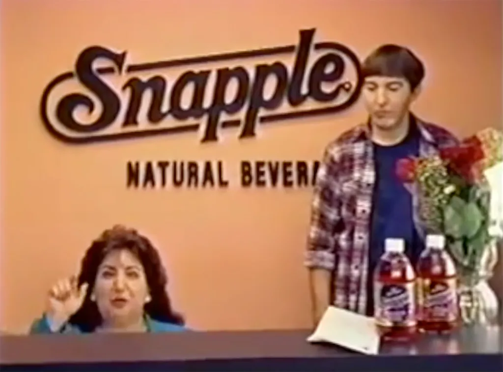 Wendy Kaufman, the Snapple Lady, with a man and Snapple bottles.