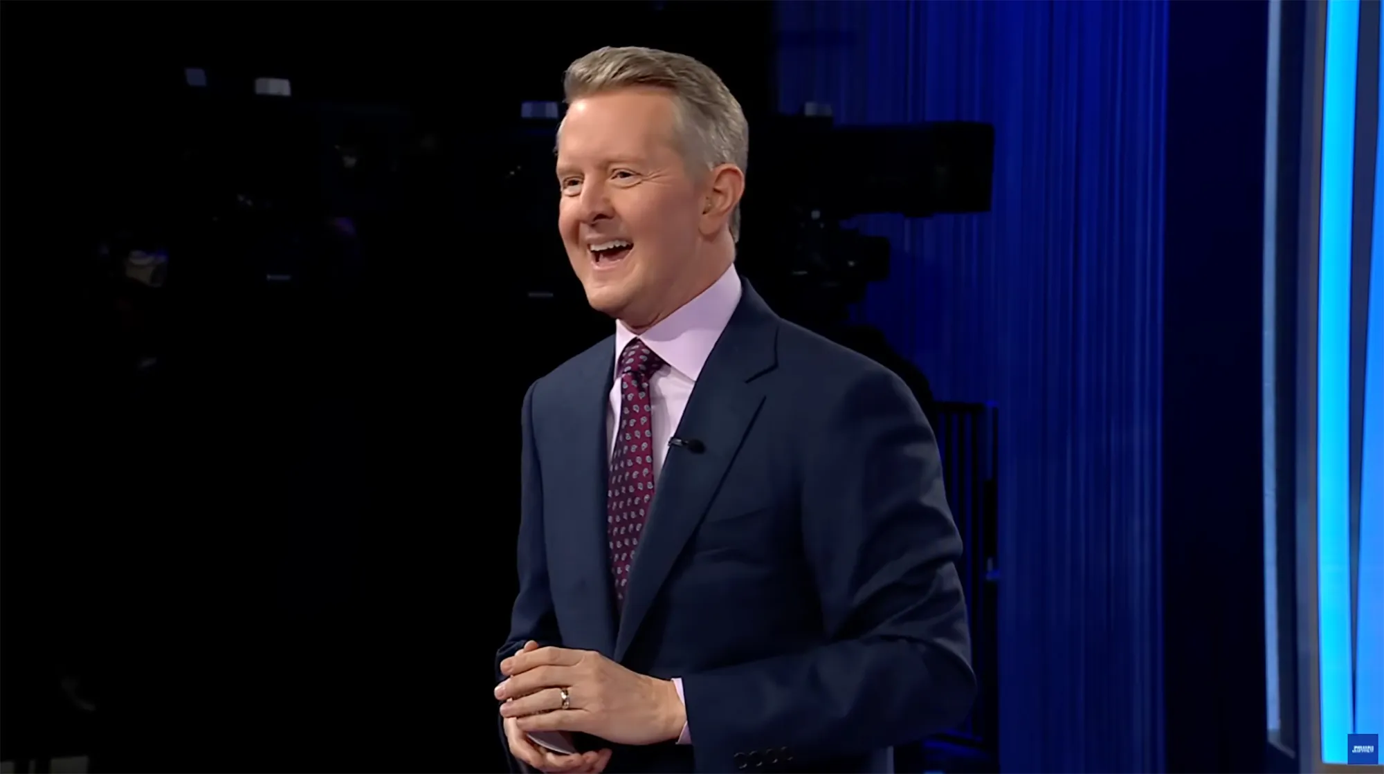 Ken Jennings smiling while wearing a suit.