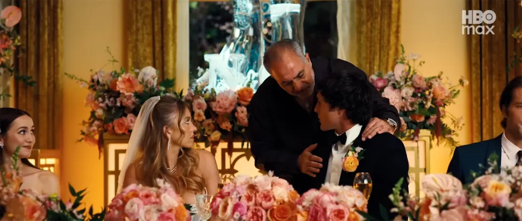 Jack Topalian with a man and two women at a wedding reception.