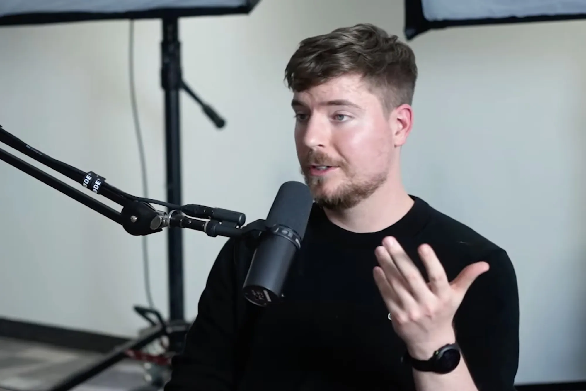YouTuber MrBeast speaking into a microphone during an interview.