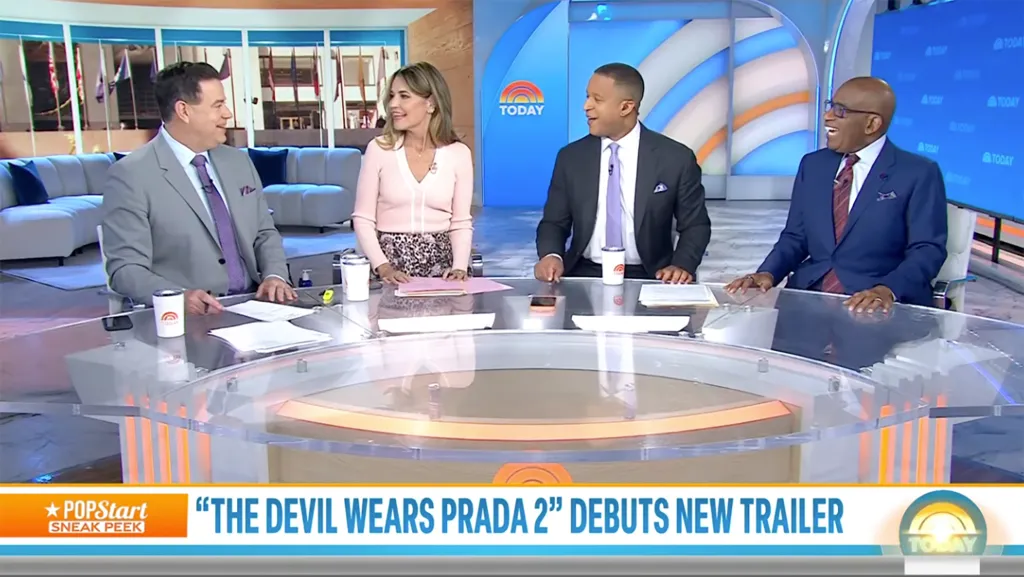 Four people, two men in suits and two women, seated at a curved desk on the Today show set.