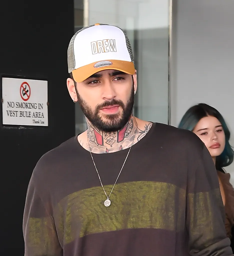 Zayn Malik wearing a white and gold "Drew" hat.