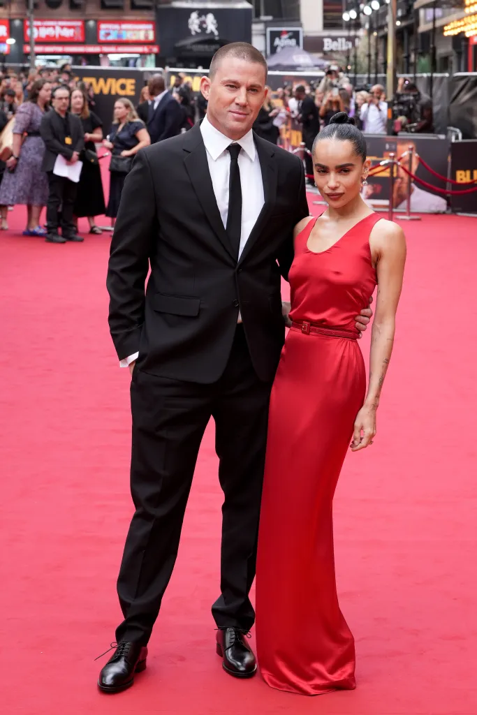 Channing Tatum in a black suit and Zoe Kravitz in a red dress attend the European premiere of Blink Twice.