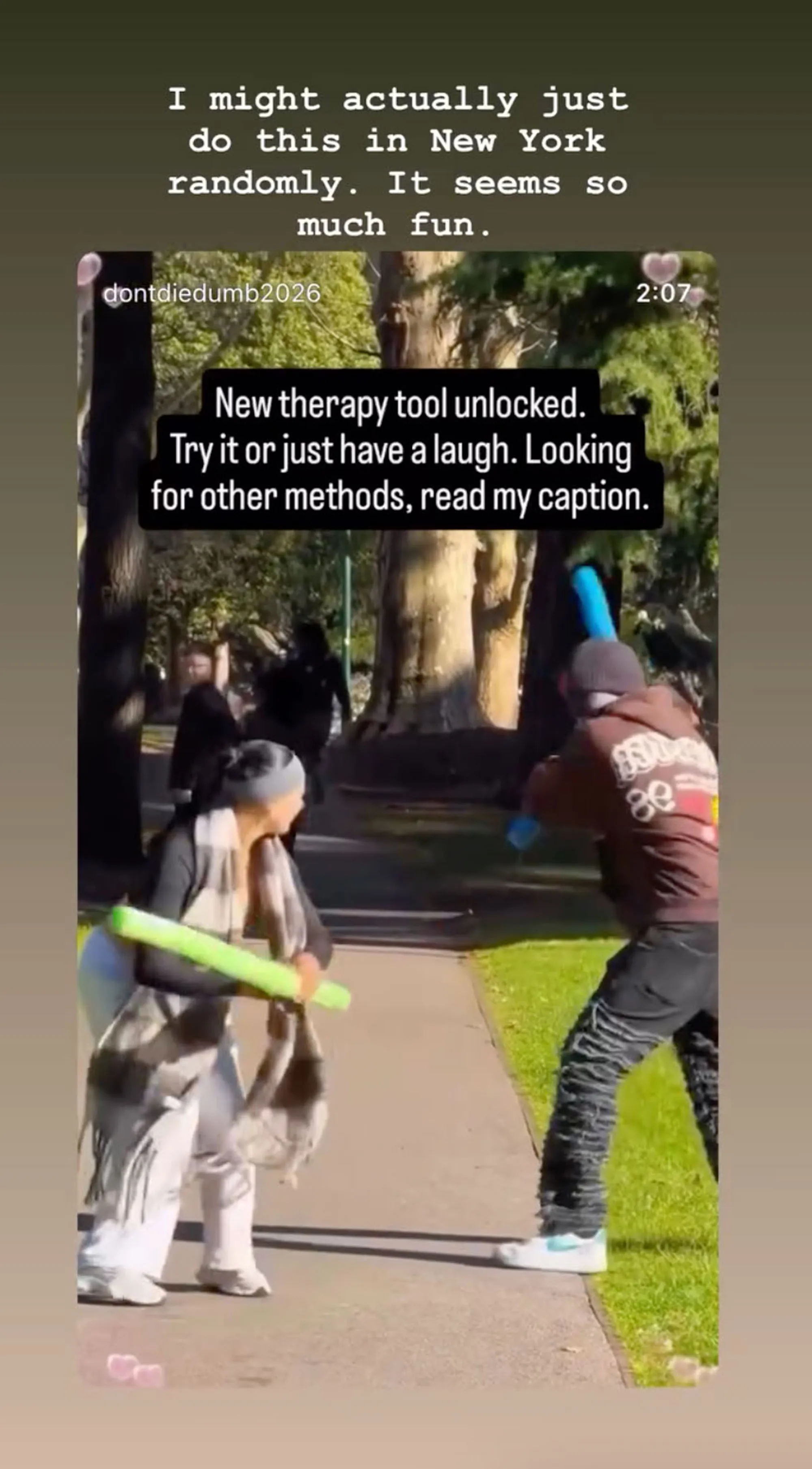Two people fighting with foam swords outdoors.