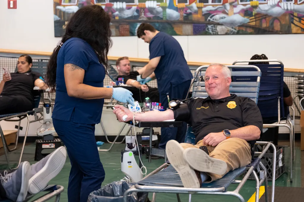 People donating blood at a blood drive.